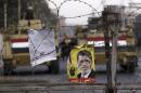 A poster of ousted Egyptian President Mursi is pictured on barbed wires during a protest by his supporters in Cairo