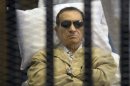 FILE - In this Saturday, June 2, 2012 file photo, Egypt's ex-President Hosni Mubarak lays on a gurney inside a barred cage in the police academy courthouse in Cairo, Egypt. An Egyptian appeals court on Sunday overturned Hosni Mubarak's life sentence and ordered a retrial of the ousted leader in the killing of hundreds of protesters, a ruling likely to further unsettle a nation still reeling from political turmoil and complicate the struggle of his Islamist successor to assert his authority. (AP Photo, File)