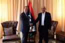 United Nations' envoy to Libya Martin Kobler (L) shake hands with the head of the internationally-recognised Libyan parliament, Aguila Saleh, in the eastern city of Tobruk on April 18, 2016