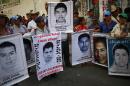 Relatives hold up posters of the 43 missing students of the Ayotzinapa Teacher Training College during a protest outside the federal court in Chilpancingo, in the Mexican state of Guerrero