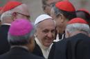 Pope Francis is surrounded by cardinals as he arrives for a pastoral visit in Assisi