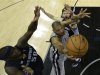 Spurs forward Duncan goes up for the shot as he is defended by Grizzlies forward Randolph and center Gasol during their NBA basketball game in San Antonio, Texas
