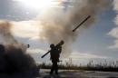 A Ukrainian soldier fires a missile with a portable air-defense system during exercises near the city of Shchastya, north of Lugansk in eastern Ukraine on December 1, 2014