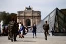 Soldiers patrol around the Louvre Museum in Paris on September 10, 2016, as part of the "operation sentinelle" launched after January 2015 attacks