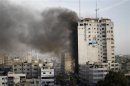 Smoke is seen after an after an Israeli air strike, witnessed by a Reuters journalist, out of a floor in a building that also houses media offices in Gaza City