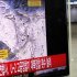 A passenger walks past a television report on North Korea's nuclear test at a railway station in Seoul