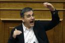 Greek Finance Minister Euclid Tsakalotos speaks during a parliament committee in Athens, Wednesday, July 22, 2015. Greece's parliament has begun an emergency debate on a second round of conditions demanded by international creditors for a new bailout - a vote that could threaten the coalition government. (AP Photo/Thanassis Stavrakis)