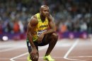 Jamaica's Asafa Powell looks at the scoreboard after running in the men's 100m final during the London 2012 Olympic Games at the Olympic Stadium