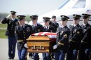 The body of U.S. Army nurse Capt. Bruce Kevin Clark who died in Afghanistan, carried across the tarmac during Military honors at Rochester International Airport Saturday, May 12, 2012. Military officials say Clark's wife, Susan Orellana-Clark, was in Texas Skyping with him on April 30 when he collapsed. Army officials say the investigation into the death is continuing. (AP Photo/Gary Wiepert)