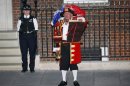 A town crier announces the royal birth outside the Lindo Wing of St Mary's Hospital after Catherine, Duchess of Cambridge gave birth to a baby boy in central London