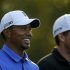Woods of the U.S. smiles as he and compatriot Bradley walk off the 11th tee during a practice round in preparation for the 2013 Masters golf tournament in Augusta