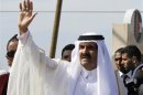 The Emir of Qatar waves to the crowd upon his arrival at a cornerstone laying ceremony in Gaza City