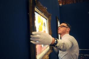 A Sotheby's staff member hangs Kees Van Dongen's "La …