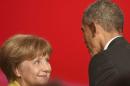 U.S. President Obama speaks to German Chancellor Merkel during the opening ceremony of the Hannover Messe in Hanover