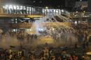 Riot police fire teargas to disperse protesters, after thousands of protesters blocked the main street to the financial Central district outside the government headquarters in Hong Kong