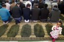 Muslims pray during the Eid al-Adha festivities at an assembly hall of the protestant church of Payerne宰牲節