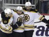 Boston Bruins' Brad Marchand, center, celebrates his goal with teammates Patrice Bergeron (37) and Johnny Boychuk (55) in the first period of Game 2 of the NHL hockey Stanley Cup playoffs Eastern Conference finals against the Pittsburgh Penguins in Pittsburgh on Monday, June 3, 2013. (AP Photo/Gene J. Puskar)