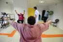 Obese patients exercise in an obesity unit at a hospital in Angers, western France, on October 23, 2013