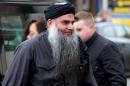 Terror suspect Abu Qatada arrives at his home in northwest London on November 13, 2012, after he was released from prison
