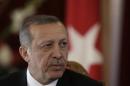Turkey's President Recep Tayyip Erdogan listens during a news conference in Riga