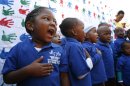 Children from Thanduxolo day care sing outside the Mediclinic Heart Hospital where former South African President Nelson Mandela is being treated in Pretoria, South Africa Wednesday, June 26, 2013. South Africa's president Jacob Zuma on Tuesday urged his compatriots to show their appreciation for Nelson Mandela, who is in critical condition in a hospital, by marking his 95th birthday next month with acts of goodness that honor the legacy of the anti-apartheid leader. (AP Photo/Themba Hadebe)
