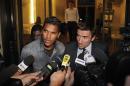 Brazilian striker Brandao, left, and his lawyer Olivier Martin answer media as they leaves the French league disciplinary hearing, in Paris, Thursday, Sept. 18, 2014. Brandao attends a French league disciplinary hearing for headbutting Paris Saint-Germain midfielder Thiago Motta and breaking his nose after a match between PSG and Bastia last month. He has already been provisionally suspended but could face a lengthy ban. (AP Photo/Thibault Camus)