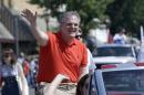 This photo taken June 14, 2014 shows Sen. Mark Pryor, D-Ark. riding the the Pink Tomato Festival parade as he campaigns in Warren, Ark. In a state where Democrats have become an endangered species in the past decade, the televised onslaught ought to have long since laid flat the Senate incumbent perhaps most vulnerable come November. (AP Photo/Danny Johnston)