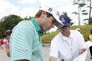 Ben Martin signs an autograph after a practice round for the PGA Championship golf tournament Tuesday, Aug. 11, 2015, at Whistling Straits in Haven, Wis. (AP Photo/Julio Cortez)