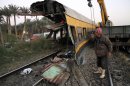 Egyptians railway workers attempt to remove debris from tracks following a train crash in Badrasheen, 40 KM south of Cairo, Egypt, Tuesday, Jan. 15, 2013. At least 19 people died and more than 100 were injured when two railroad passenger cars derailed just south of Cairo, health officials say. The accident comes less than two weeks after a new transportation minister was appointed to overhaul the rail system, and just two months after a deadly collision between a train and school bus. (AP Photo/Ahmed Gomaa)