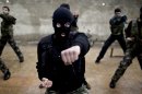 In this Monday, Dec. 17, 2012 photo, Syrian rebels attend a training session in Maaret Ikhwan, near Idlib, Syria. The training is part of an attempt to transform the rag-tag rebel groups into a disciplined fighting force. (AP Photo/Muhammed Muheisen)