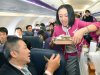 In this March 1, 2012 photo, a passenger buys a meal during the first flight by Peach Aviaction from Osaka, western Japan, bound for Sapporo, northern Japan. Japan has a reputation for loving expensive things like overpriced real estate, gourmet melons and luxury brands. But the nation is finally discovering the joy of flying cheap, with the arrival this year of three low-cost carriers. The takeoff of AirAsia Japan, Peach Aviation and Jetstar Japan could change lifestyles. (AP Photo/Kyodo News) JAPAN OUT, MANDATORY CREDIT, NO LICENSING IN CHINA, FRANCE, HONG KONG, JAPAN AND SOUTH KOREA