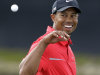 Tiger Woods looks back to catch a ball after his caddie cleaned it on the eighth green during the final round of the Cadillac Championship golf tournament on Sunday, March 10, 2013, in Doral, Fla. Woods won the championship. (AP Photo/Wilfredo Lee)