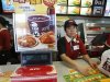 A KFC worker attends to a customer at a KFC outlet in Beijing
