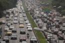 FILE - In this June 1, 2012 file photo, vehicles drive on a highway in Sao Paulo, Brazil. The Brazilian government may delay "by one or two years" the implementation of a law forcing automakers to install frontal air bags and anti-lock braking systems in all new cars, the finance minister said Wednesday, Dec. 11, 2013. Safety advocates decried the idea of any delay, saying that in terms of safety, Brazilian cars are already decades behind those produced for consumers in the U.S. and Europe, despite Brazil now being the globe's No. 4 auto market. (AP Photo/Andre Penner, File)