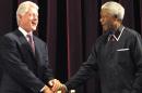 File photo taken on July 19, 2003 shows former US President Bill Clinton (L) shaking hands with former South African President Nelson Mandela at the Johannesburg Civic Centre