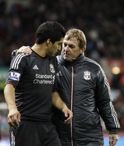 Liverpool's Luis Suarez, left, is congratulated by his manager Kenny Dalglish after scoring both the goals during the team's 2-1 victory over Stoke in their English League Cup soccer match at the Britannia Stadium, Stoke, England, Wednesday, Oct. 26, 2011. (AP Photo/Jon Super)