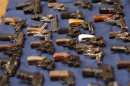 A view shows confiscated guns on a table during a news conference on major firearms trafficking cases at a news conference in New York