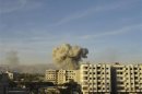 Smoke rises after a Syrian Air Force fighter jet loyal to Syria's President Bashar al-Assad fired missiles at Hamouria, near Damascus