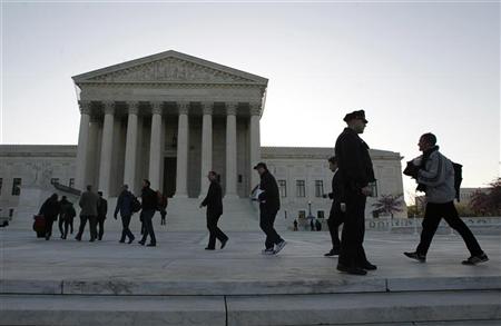 Members of the public who received tickets enter into the Supreme Court in Washington, March 27, 2012. REUTERS/Jason Reed