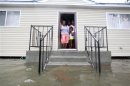 A family stands on their front porch as Hurricane Isaac makes land fall in New Orleans