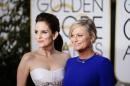 Show hosts Tina Fey and Amy Poehler arrive at the 72nd Golden Globe Awards in Beverly Hills