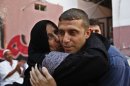 Nehad Jondiya, a Palestinian released after 24 years in an Israeli jail, hugs his sister, Um rami, at his family's house in Gaza City on Wednesday, Aug. 14, 2013. Israelis and Palestinians were to hold their first formal peace talks on home turf in the Middle East in nearly five years Wednesday, hours after Israel released 26 long-held Palestinian prisoners who were given a boisterous homecoming by cheering crowds. (AP Photo/Adel Hana)