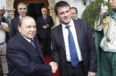 Algerian President Bouteflika shakes hands with French Interior Minister Valls upon his arrival at the Presidential Palace in Algiers