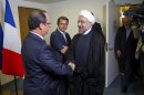 Iranian President Hasan Rouhani, right, meets with French President Francois Hollande during the 68th session of the United Nations General Assembly at United Nations headquarters Tuesday, Sept. 24, 2013. (AP Photo/Craig Ruttle)