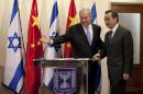 Israeli Prime Minister Benjamin Netanyahu, left, directs Chinese Foreign Minister Wang Yi to a podium for a press conference before their meeting at the prime minister's office in Jerusalem, Wednesday, Dec. 18, 2013. (AP Photo/Abir Sultan, Pool)