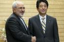 Iran's FM Zarif shakes hands with Japanese PM Abe at the start of talks in Tokyo