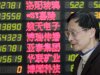 An investor looks at the stock price monitor at a private securities company on Thursday, March 28, 2013, in Shanghai, China. Renewed jitters about the debt crisis in Europe sent Asian stock markets lower Thursday. (AP Photo/Eugene Hoshiko)