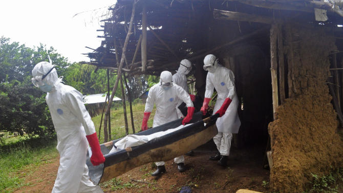 Ebola health care workers carry the body of a middle aged man that they suspected of dying from the Ebola, on the outskirts of Monrovia, Liberia, Saturday, Nov. 8, 2014. Dr. Robert Fuller didn&#39;t hesitate to go to Indonesia to treat survivors of the 2004 tsunami, to Haiti to help after the 2010 earthquake or to the Philippines after a devastating typhoon last year. But he&#39;s given up on going to West Africa to care for Ebola patients this winter.  (AP Photo/ Abbas Dulleh)