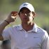 Rory McIlroy of Northern Ireland leaves the 18th green at the end of his match during the second round of the Abu Dhabi Golf Championship