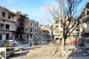 Syrians inspect damaged buildings in the key rebel-held bastion of Yabrud, on February 21, 2014